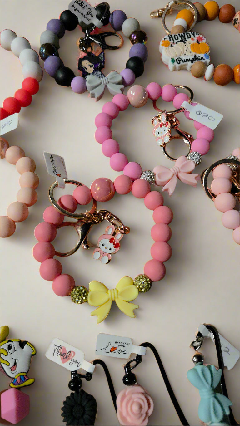 Collection of colorful bracelets and keychains on a light background